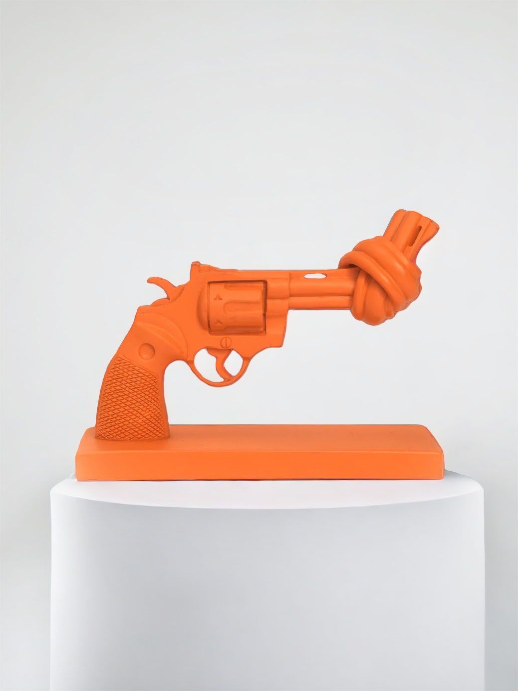 The Knotted Gun tangerine orange sculpture.
