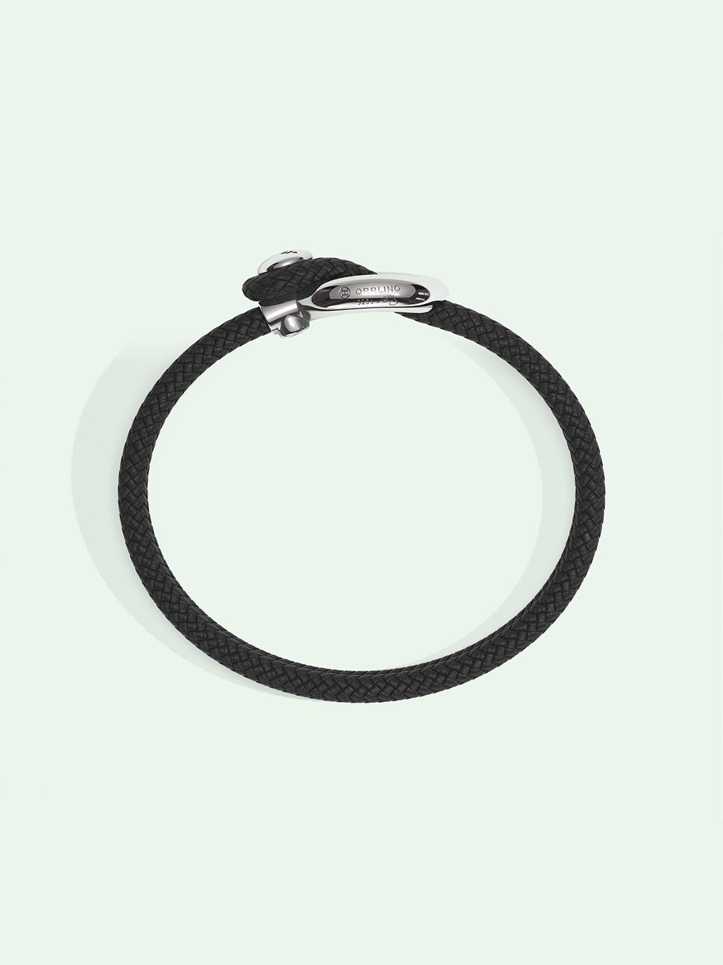 Imagine black nylon bracelet by Orrling in a top view created in collaboration with the Non-Violence Project.