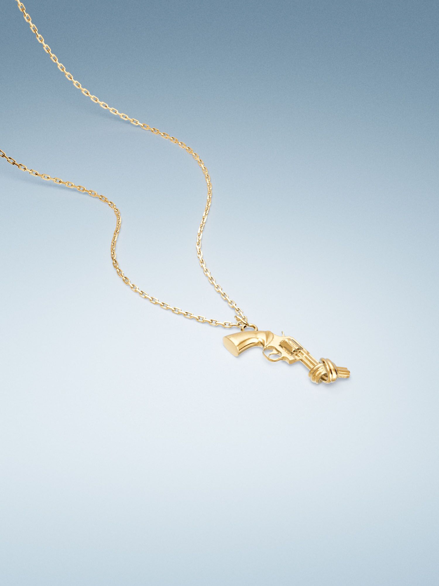 Vacier Chain Necklace Gold for women with the Non-Violence Knotted Gun pendant close up view