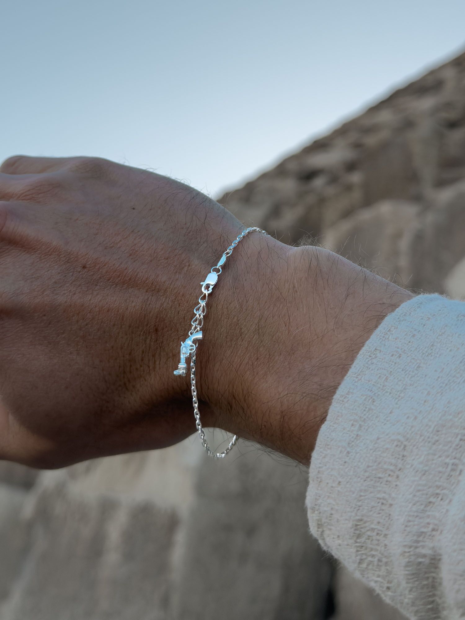 Vacier Chain Bracelet Silver for Men with the Non-Violence Knotted Gun pendant on a model